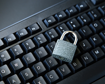 Close up of a computer keyboard with a padlock on top
